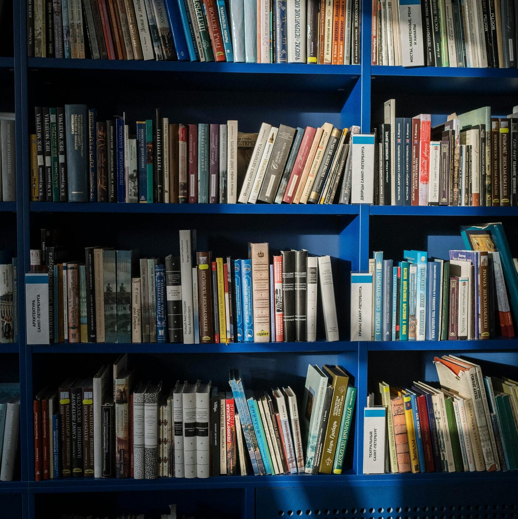 Vertical shot of bookshelves filled with a variety of books in a library setting, emphasizing knowledge and education.